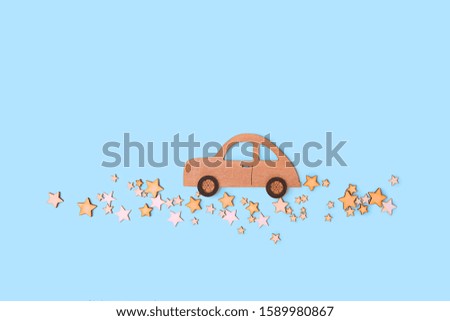 toy vintage car and star road on blue background. flat lay. copy space. New Year, Christmas, father's day holidays concept.