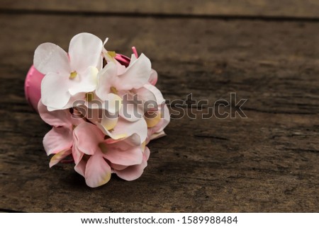 Pastel pink hydrangea flowers bouquet on a wooden backround with copy space for text.