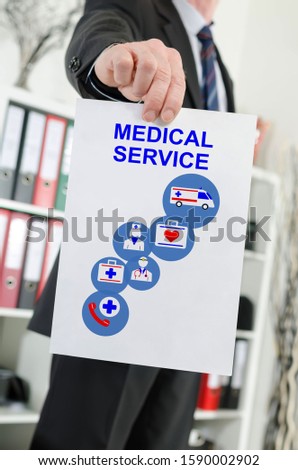 Paper showing medical service concept held by a businessman