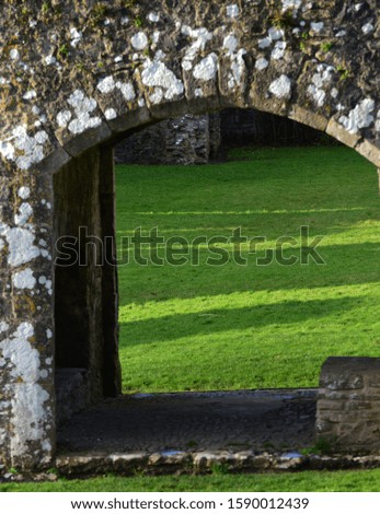 stone arched entrance to ruined castle 