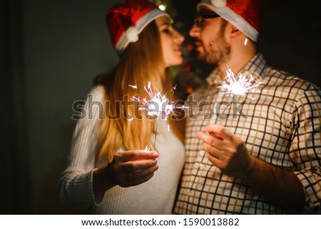 Picture of happy couple with sparklers. On black background