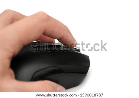 black computer mouse in hand isolated on a white background. Close-up.