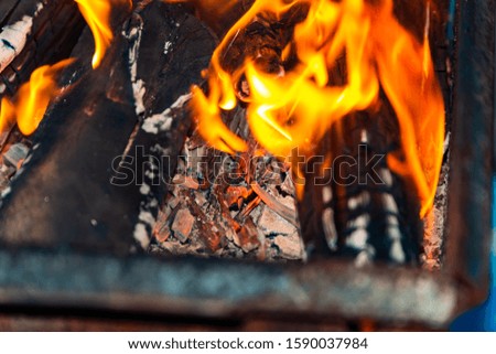 Burning fire in a barbecue grill for frying meat on the street.