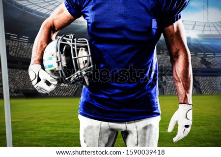 American football player against digital image of rugby stadium