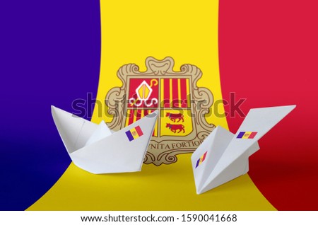Andorra flag depicted on paper origami airplane and boat. Handmade arts concept