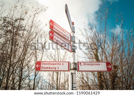 Signpost of Dutch cities in Zeeland, Netherlands of Domburg, Zierikzee, Veere, Vrouwenpolder, Kamperland, to guide traffic, cyclists and tourists
