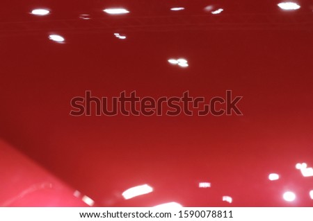 The red texture of the car hood is beautiful.