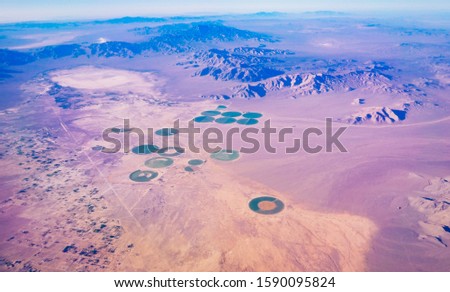 Aerial view of green circle formed center pivot irrigation farm system in North of Area 51, Nevada State, USA Royalty-Free Stock Photo #1590095824