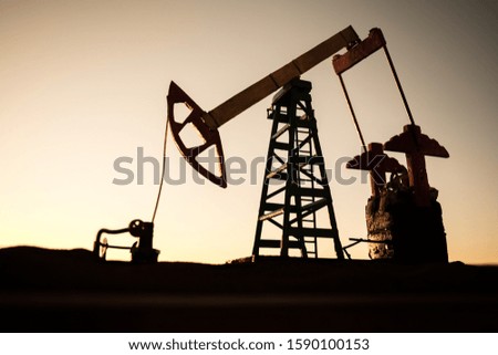 Oil pump and oil refining factory at sunset. Energy industrial concept. Selective focus. Creative artwork decoration.