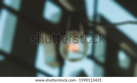 Blurred abstract background of glowing flashing light bulb lamp.