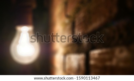 Blurred abstract background of glowing flashing light bulb lamp.