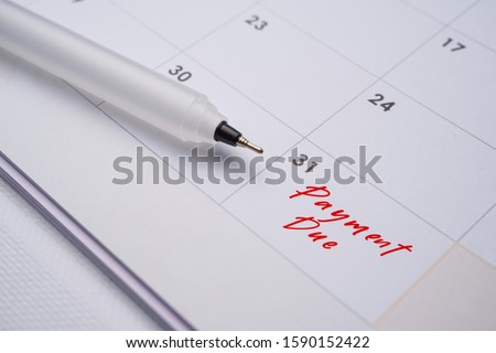 Mortgage payment due on the end of every month. image with pen and calendar  Royalty-Free Stock Photo #1590152422