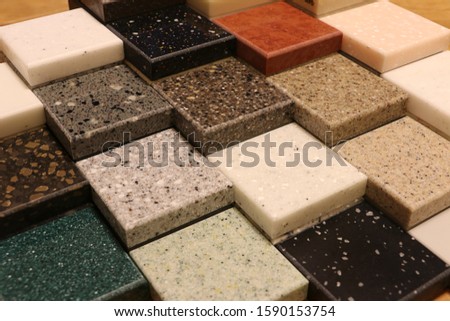 Top view of color samples stone  on oak wood table, Acrylic Solid Surface Royalty-Free Stock Photo #1590153754