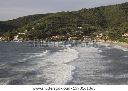 Waves from storm in the Bay of Biodola with view to Scalieri, Elba, Tuscany, Italy