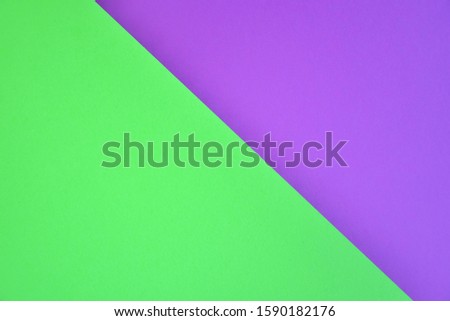 Two tone paper background with violet and neon green color. Blank colorful backdrop with empty space for image or text. Mockup concept. Neon empty paper background. Clean purple and green wallpaper 