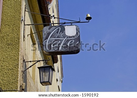 cafe sign on wall with lamp