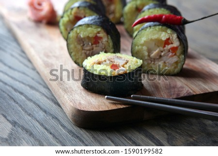 hot roll set sashimi japanese food on wooden background with lemon and chopsticks
