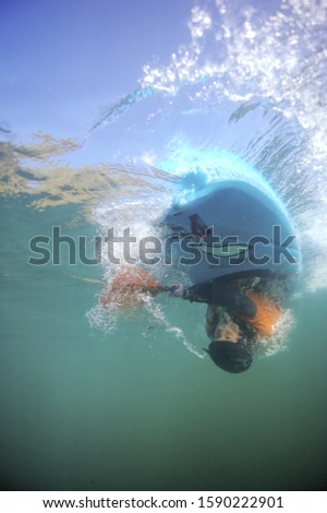 Underwater shot of person upside down in kayak