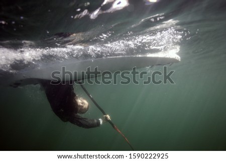 Underwater shot of person upside down in kayak