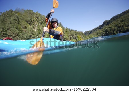 Surface shot of man paddling in kayak