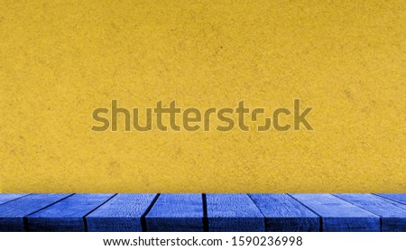 Blue display wooden board shelf table counter with copy space for advertising backdrop and background with yellow paper wall background,