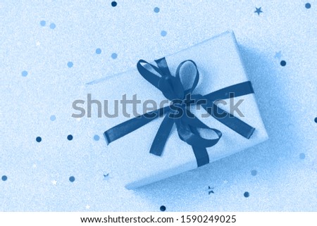 Classic blue 2020. Gradient color palette. Handmade Christmas gift box with ribbon. Top view on a flat lay background.
