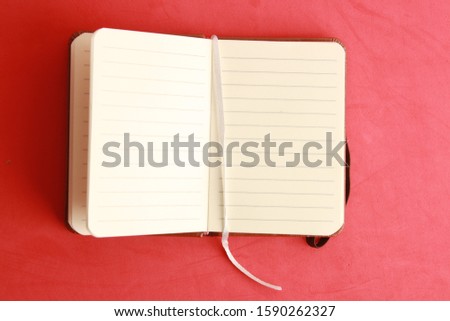 brown leather notebook open in color background