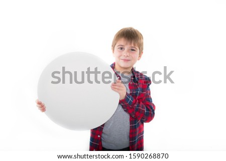 
a boy in stylish clothes holds a round canvas in his hands, a round white tablet Royalty-Free Stock Photo #1590268870
