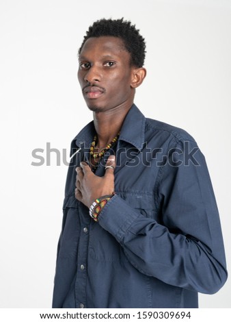 A black guy (man) in a blue shirt and jeans