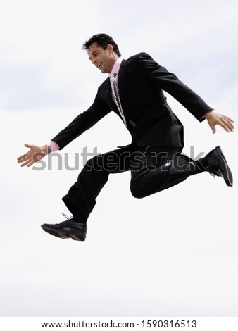 Low angle view of businessman jumping