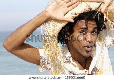 African man wearing hat at beach