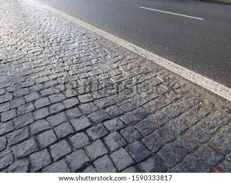 grey  cobble pavement texture wet after rain
