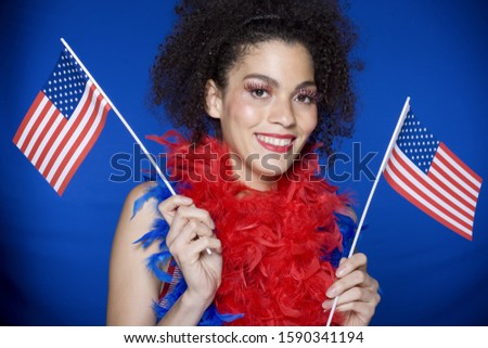 African woman holding American flags