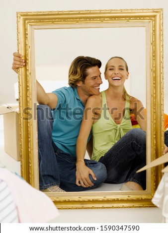 Couple sitting inside picture frame