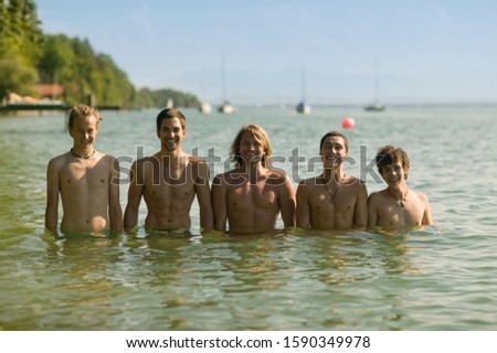 Portrait of teenage boys in lake