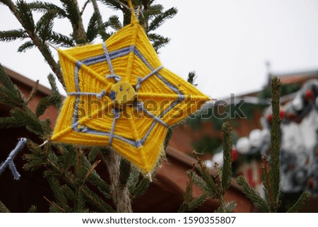 Christmas Tree Branches And Traditional Textile Yellow Star On The Christmas Market Of Historical Dortmund City, Germany.