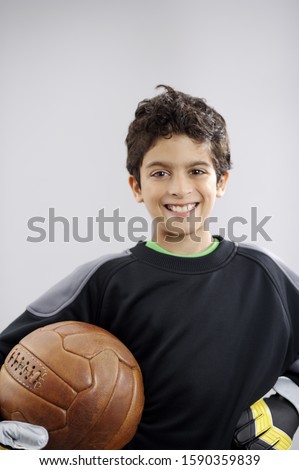Portrait of young boy with football