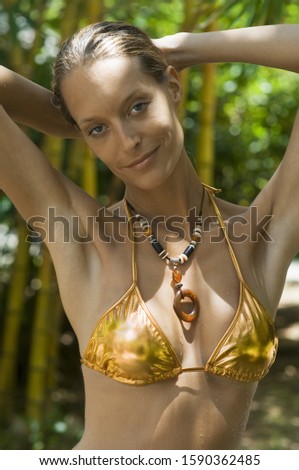 Potrait of woman in gold bikini