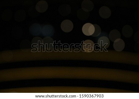 dark background with bokeh effects and golden blurred lines