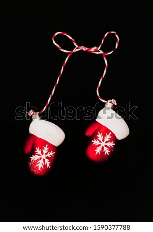 Christmas symbol red mittens with snowflakes on a black background