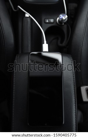 
Mobile phone, smartphone charge battery , charging in the car plug close up