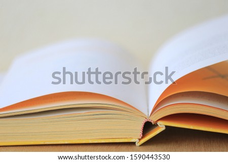 A close-up of the book opens on the library desk selective focus and shallow depth of field