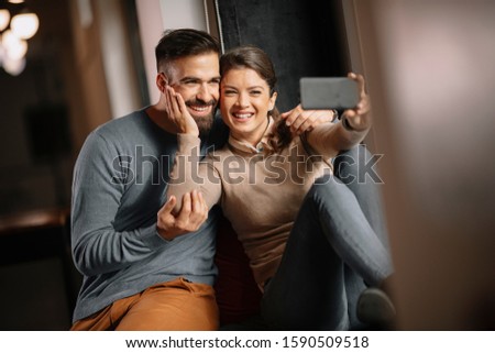 Young beautiful couple taking selfie. 