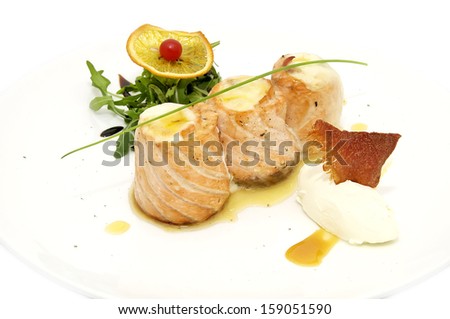 Baked fish on a white plate in a restaurant