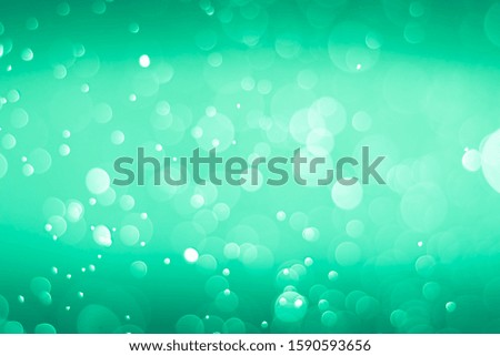 Abstract bokeh lights with green and black background. Beautiful bokeh from water droplets.
