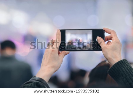 Person taking photo with smartphone, closeup view, copy space.