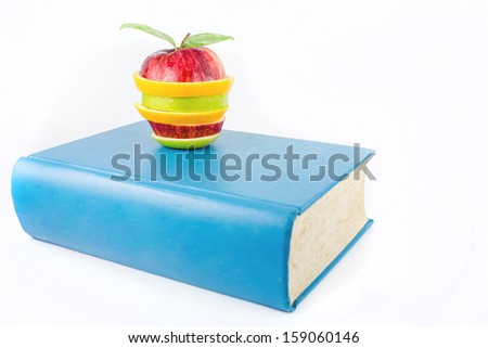 Book and an fruits on a white background 