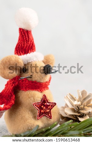 Little toy Christmas mouse, Christmas tree branch and cone. Vertical Christmas composition with the symbol of 2020 according to the Chinese horoscope