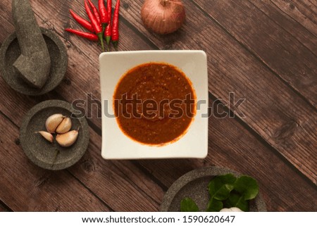 Flat lay of chili paste. Asian food condiment. Stone mortar and pestle.