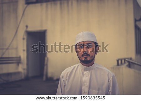 A Young asian muslim man praying on sunset,Ramadan festival concept
